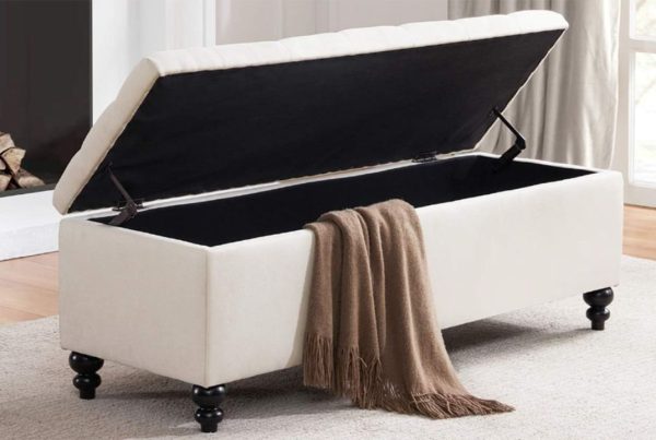 white ottoman blanket box with the lid open and a brown blanket falling out